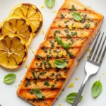 Grilled lemon herb air fryer salmon garnished with basil and zest
