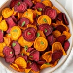 Colorful air fryer veggie chips with beets and sweet potatoes in a bowl