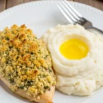 Longhorn Parmesan Crusted Chicken served with mashed potatoes and butter