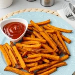 Hot and crispy Alexia sweet potato fries with ketchup in white sauce dish