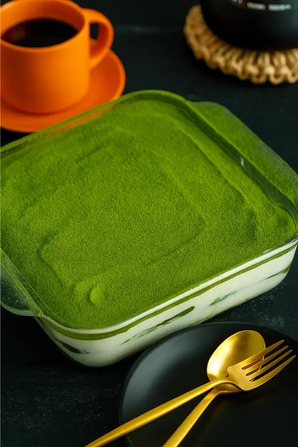 Finished matcha tiramisu with dusted top and coffee on the side