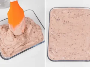 Spatula scooping churned red bean ice cream into a container and smoothing the surface