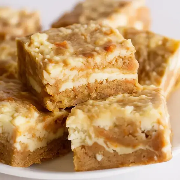 Carrot cake bars with visible cheesecake swirl