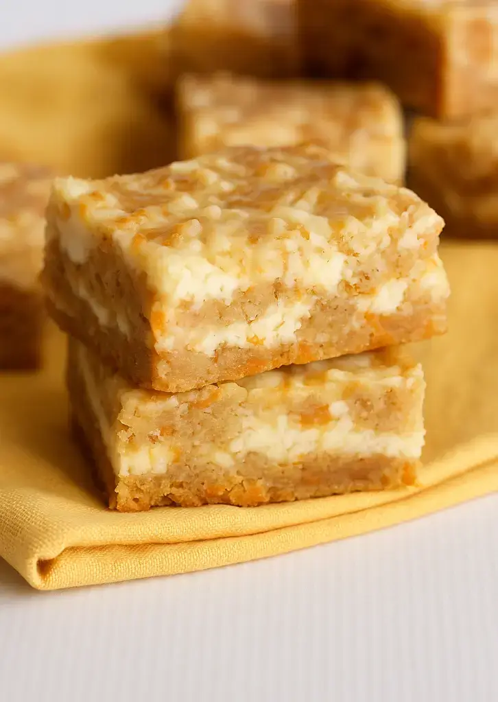 Double stack of carrot cake bars on yellow napkin
