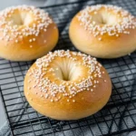 Freshly baked cottage cheese bagels cooling on rack
