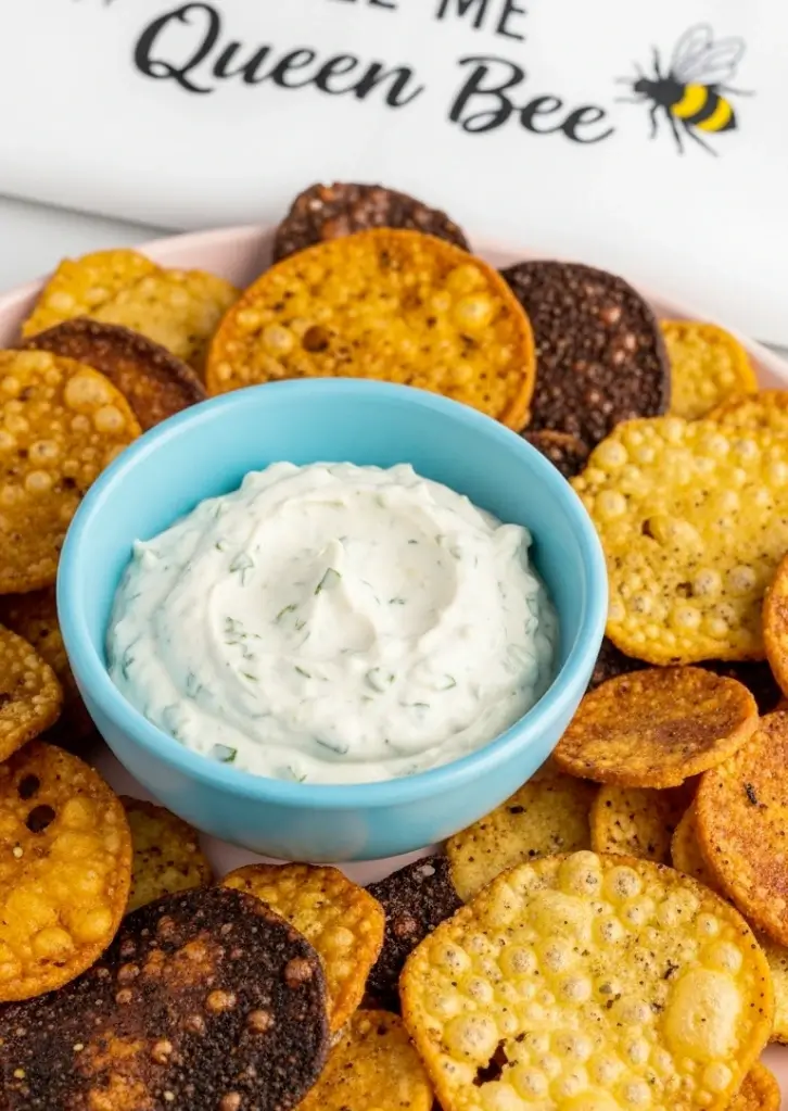 Plate of Air Fryer Cottage Cheese Chips with creamy dip in blue bowl