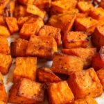 Close-up of seasoned crispy roasted sweet potato chunks
