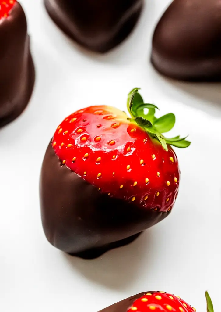 close-up of single dark chocolate dipped strawberry