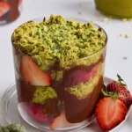 Dubai chocolate strawberries layered with pistachio and chocolate in a dessert cup