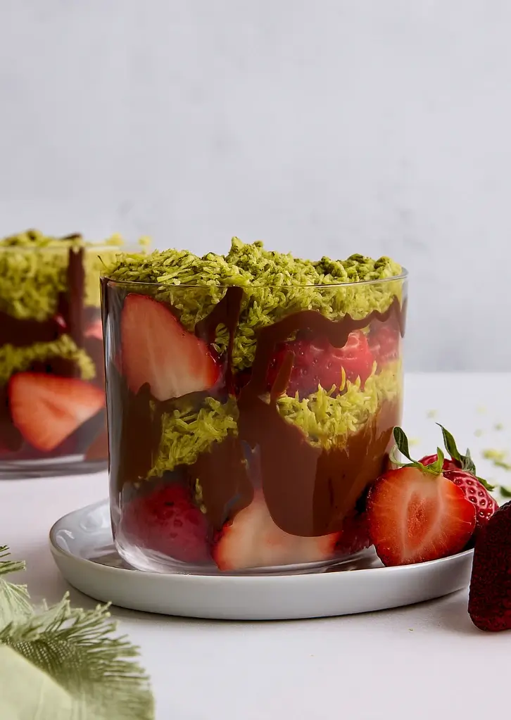 Dubai chocolate strawberries served in glass cup with whole berries