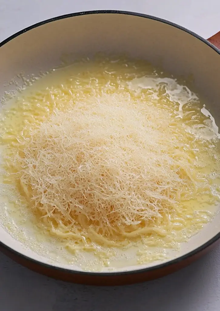 Kataifi dough being toasted in butter