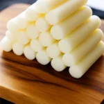 Side view of fresh Korean rice cakes stacked neatly