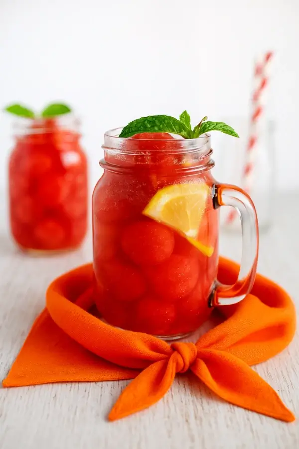 Korean watermelon punch with lemon slice and mint in a mason jar