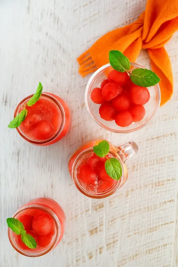 Overhead view of Korean watermelon punch served in glass jars