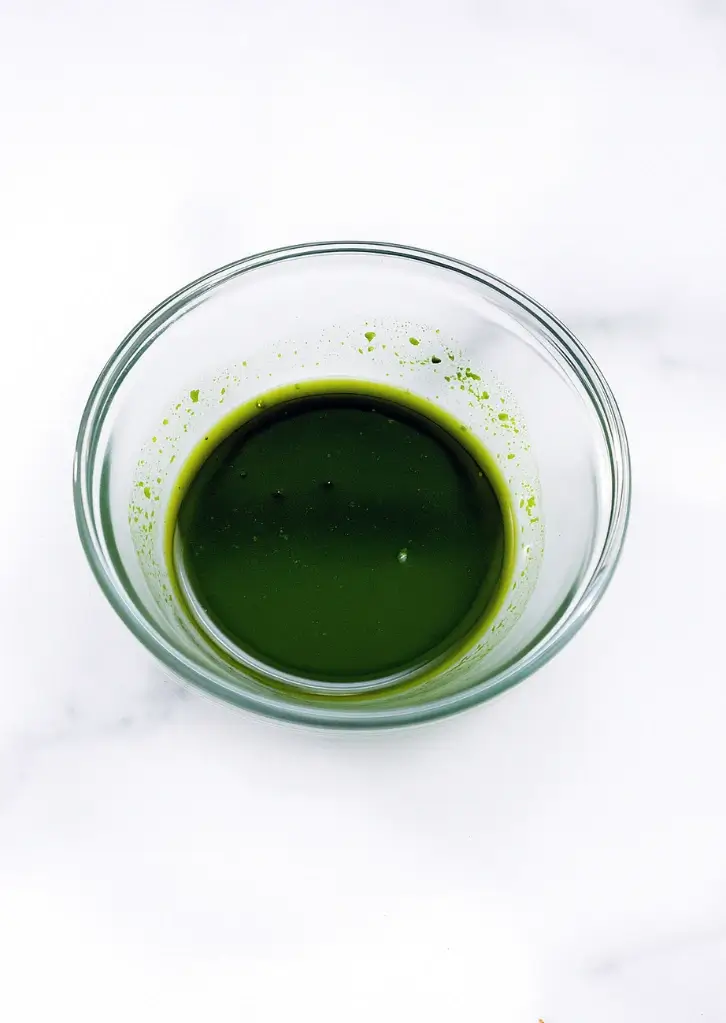 Dissolved matcha in a small glass bowl
