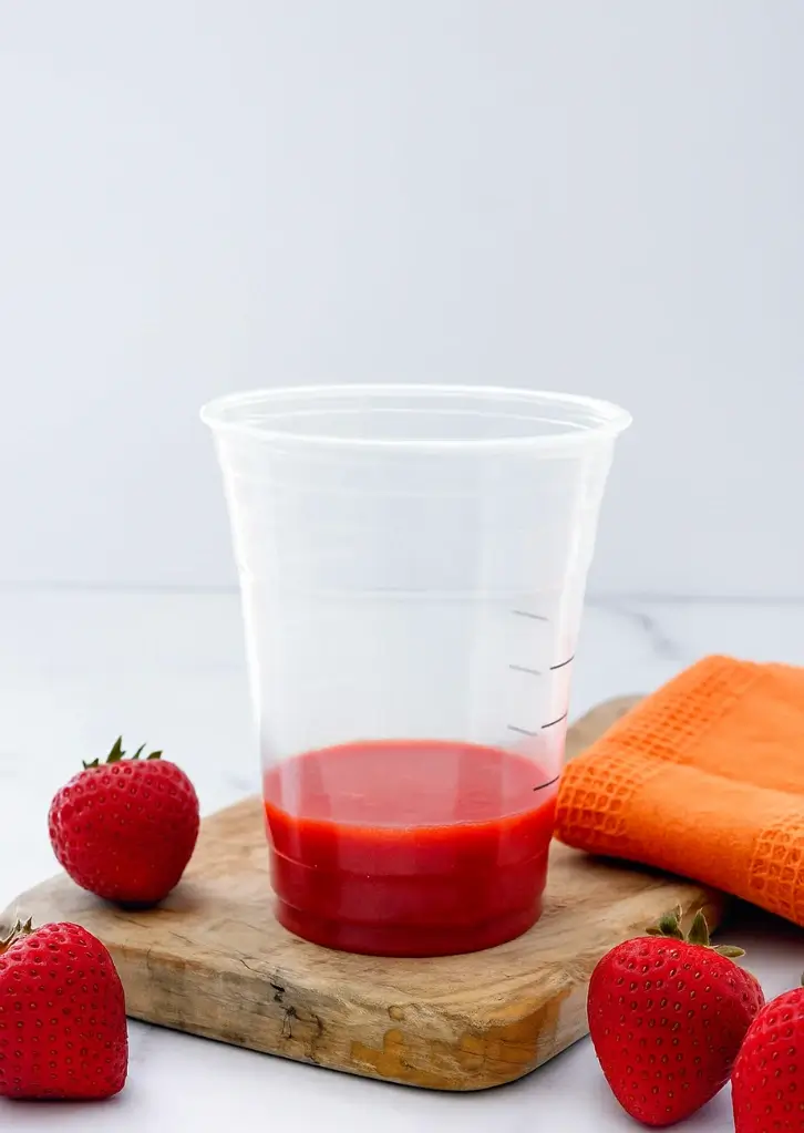 Strawberry puree at the bottom of clear cup