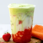 Iced strawberry matcha latte layered in clear cup
