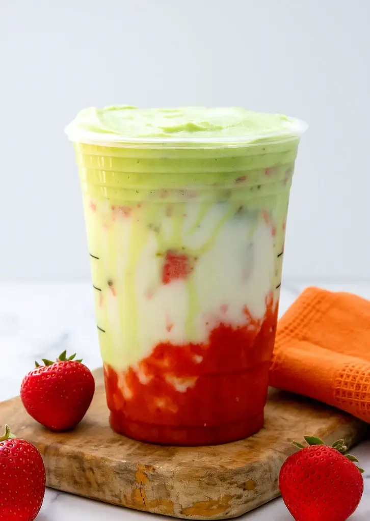 Iced strawberry matcha latte layered in clear cup