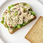 tuna salad sandwich on plate with lettuce