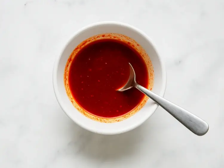 Red chili seasoning mix for Korean soup in a white bowl