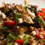 Close-up of lentil and roasted eggplant salad with dressing drizzle