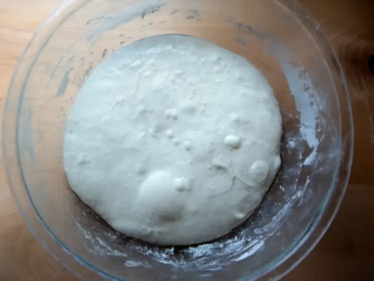 Resting dough covered with a cloth for fermentation